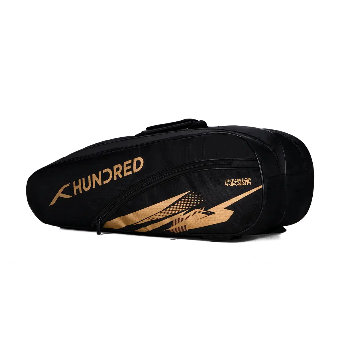 HUNDRED Cosmogear Kit Bag in black with gold branding and angular graphic accents, featuring a zippered front compartment