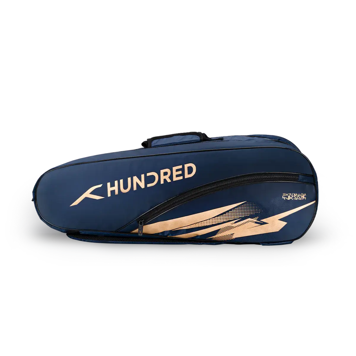 HUNDRED Cosmogear Kit Bag in navy blue with gold branding and angular graphic accents, featuring a long zippered compartment.