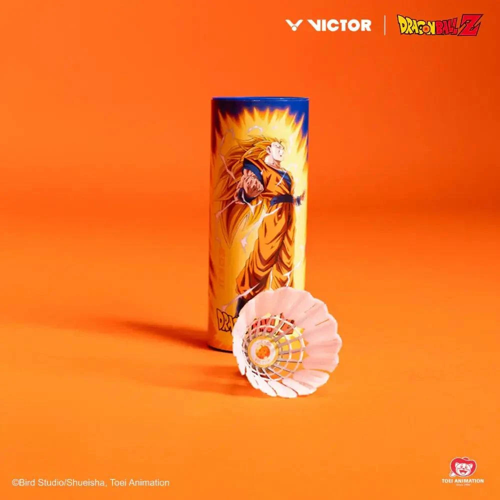 Victor Dragon Ball Z Goku synthetic shuttlecock with white feathered skirt and orange cork head beside illustrated character tube
