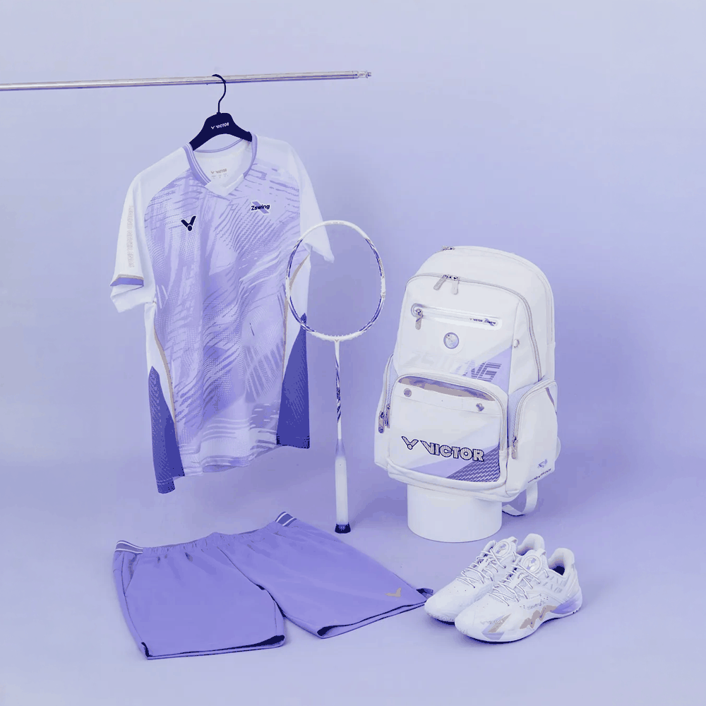 Victor DriveX 12 badminton racket with a white and purple frame, shown with matching apparel, backpack and shoes