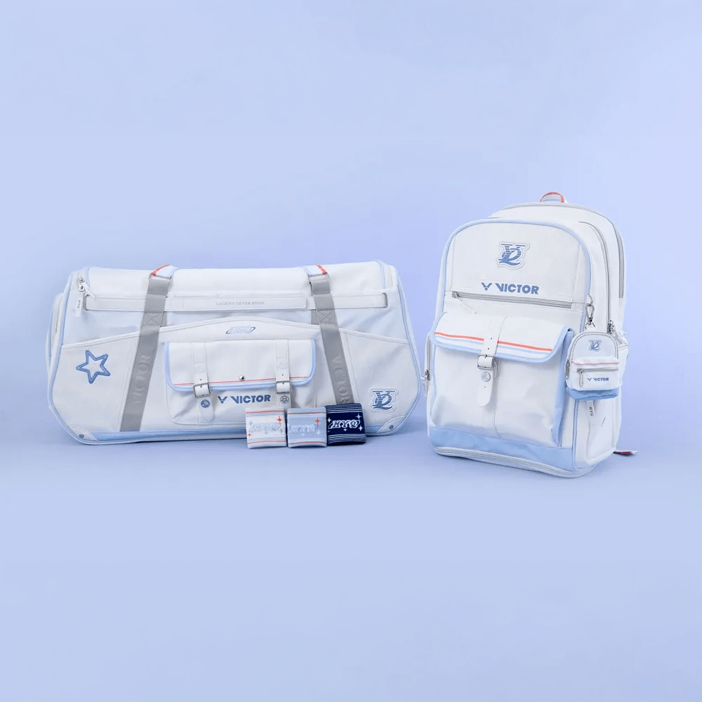 Victor HYQ backpack in bright white with blue accents, front flap pocket, star emblem and matching duffel bag