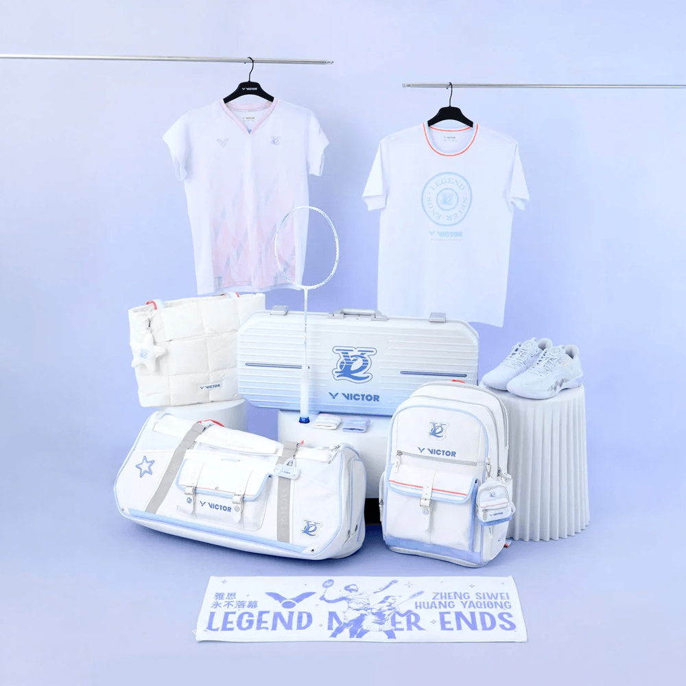 Victor HYQ backpack in bright white with blue logo, orange trim, front zip pockets and a small side pouch