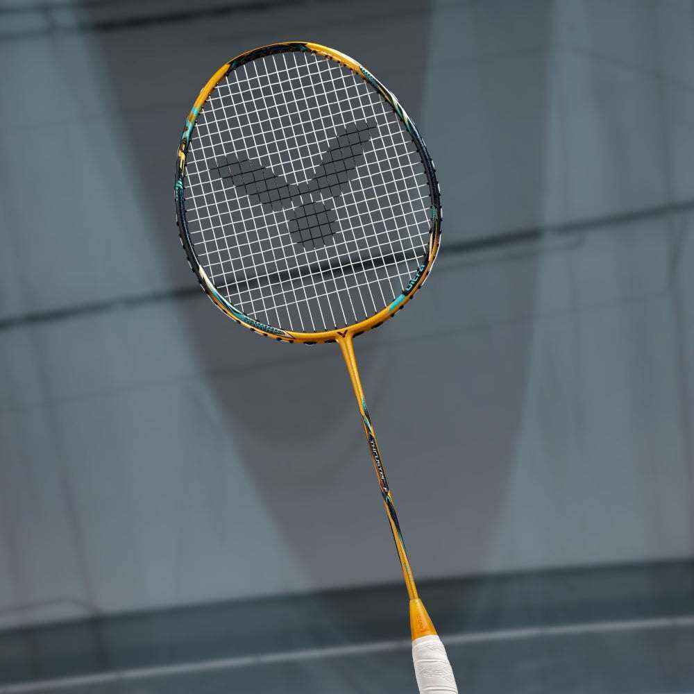 Victor Thruster F C Ultra X badminton racket with a black string bed, metallic gold frame and slim gold shaft.
