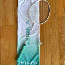 Victor TTY Soft Case in white and turquoise fabric with green lettering, holding a badminton racket with a white frame