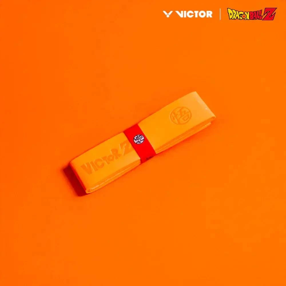 Victor x Dragon Ball Z Grip in bright orange polyurethane, wrapped with a red band featuring a Dragon Ball Z emblem.