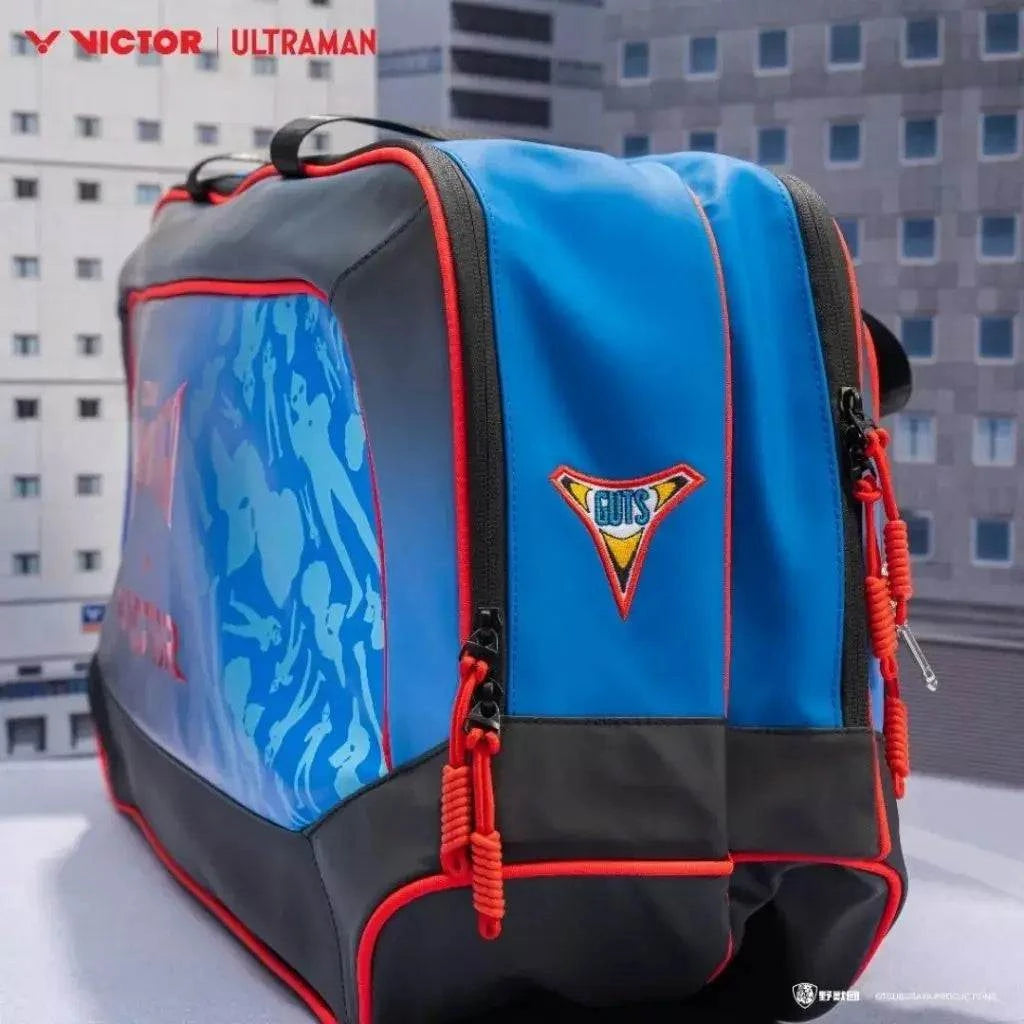 VICTOR X ULTRAMAN Collection rectangular racket bag in bright blue and black PU leather with red piping and graphic panels