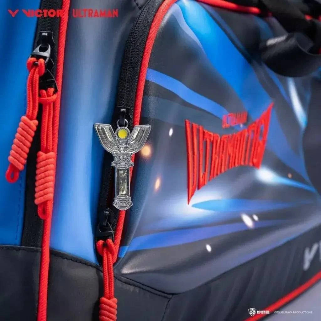 VICTOR X ULTRAMAN Collection racket bag in blue and black PU leather with red trim, printed graphic and metal zipper charm