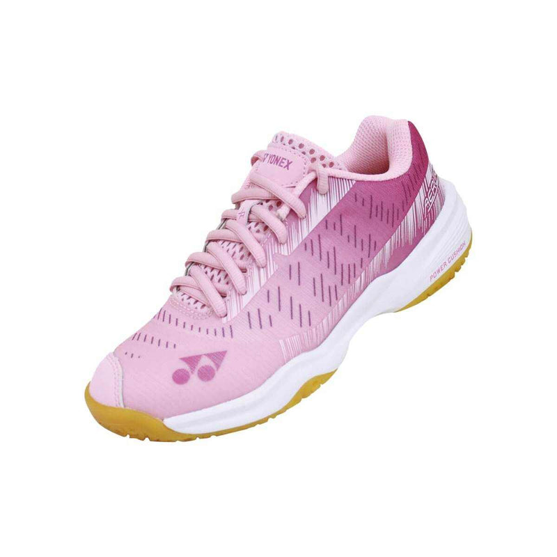 Yonex Aerus Junior Badminton Shoes in pink mesh with matching laces, subtle stripe pattern, and white midsole with gold outsole