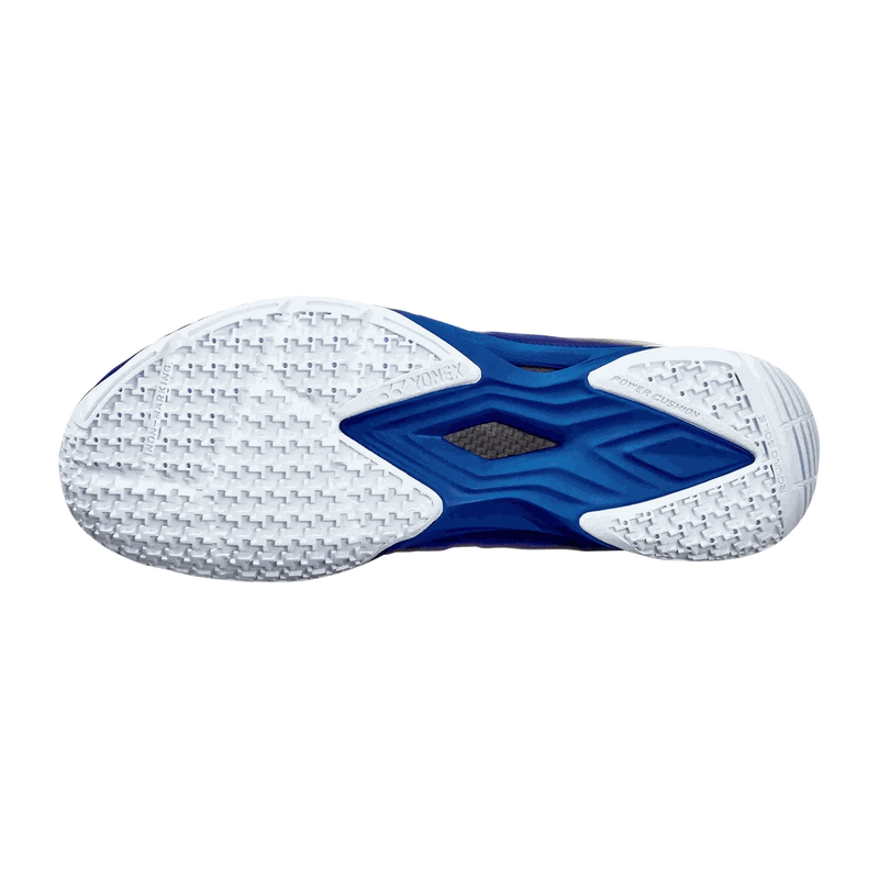 Yonex Aerus Z2 MX badminton shoe outsole in white and navy blue, with textured rubber tread and a blue midfoot support plate