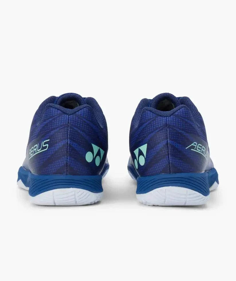 Yonex Aerus Z2 badminton shoes in navy blue with a textured patterned upper, turquoise accents, and white soles