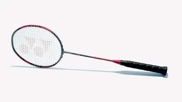 Yonex ArcSaber 11 Pro badminton racket with a black and red frame, white strings, and a black wrapped grip
