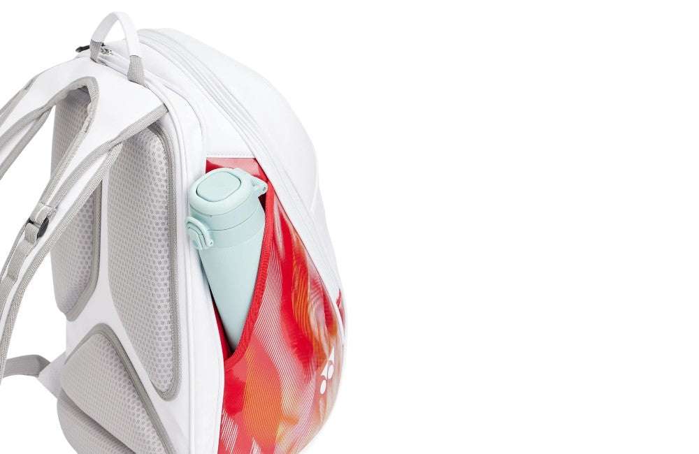 Yonex Expert Series Badminton Backpack in white with grey padded straps, a red-orange patterned side panel and mint bottle