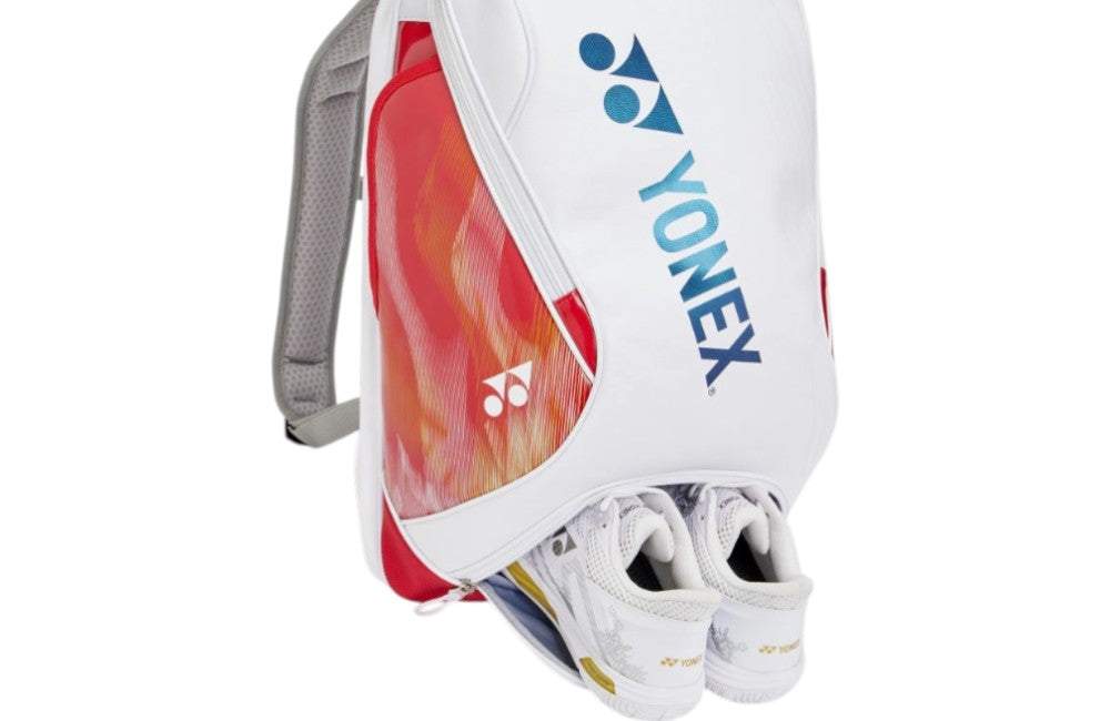 Yonex Expert Series Badminton Backpack in white with red and orange panels, blue logo, and shoes stored in the bottom compartment