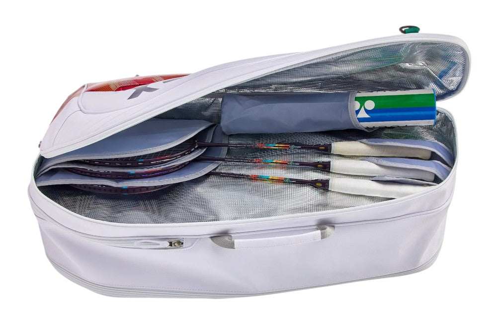 Yonex Expert Series Badminton Racket Bag in white polyester, open with rackets and a blue-green accessory pouch inside