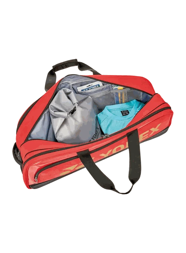 Yonex Expert Series Tournament Badminton Bag in red with black straps, open to show grey lining and clothing compartments
