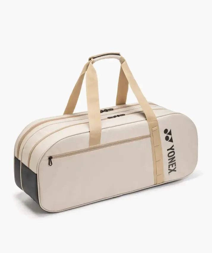 Yonex GEARLOGIC Tournament Bag in cream with tan straps, multiple zip compartments, and a black Yonex logo