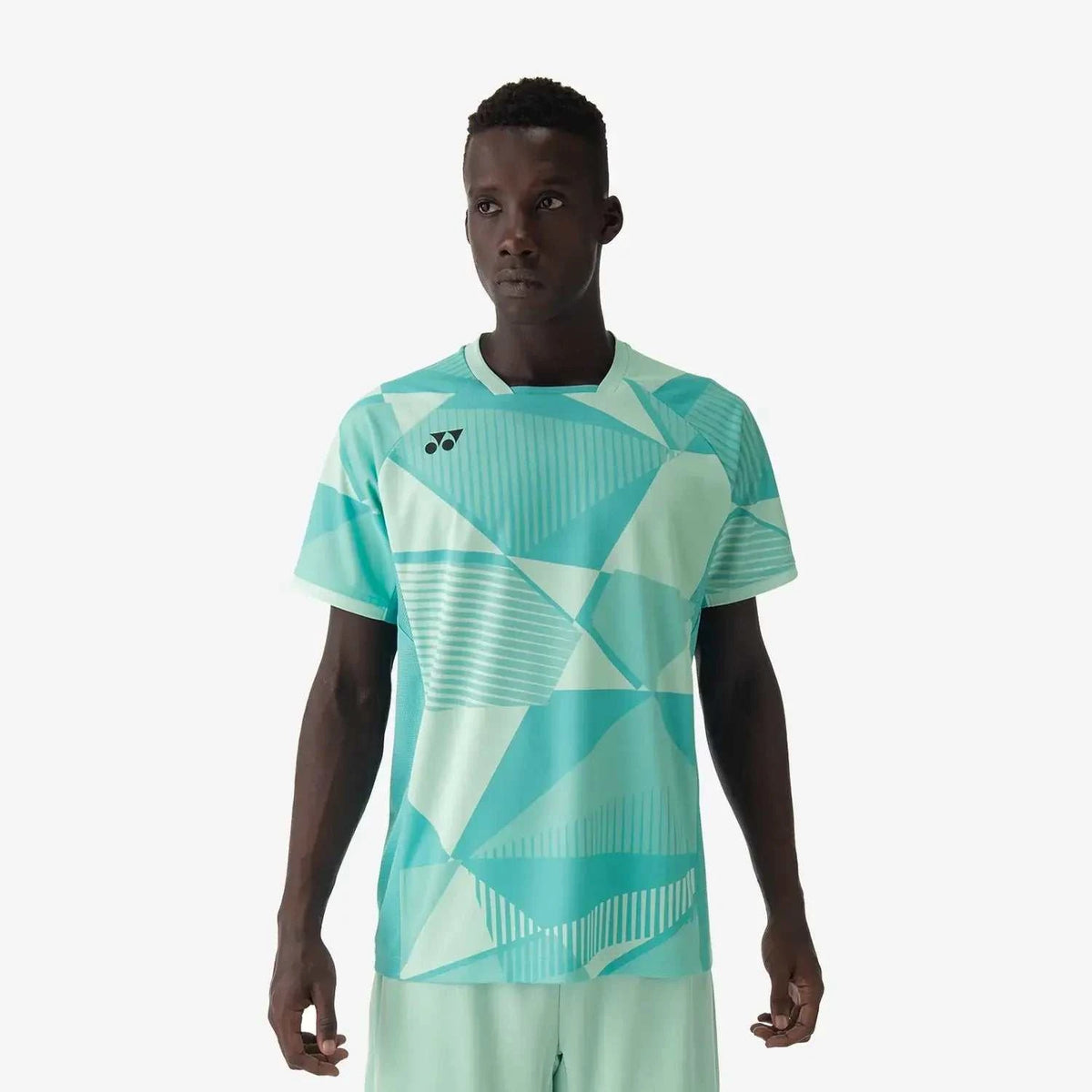 Yonex Men's Crew Neck shirt in mint with an all-over geometric pattern, short sleeves, and a ribbed collar.
