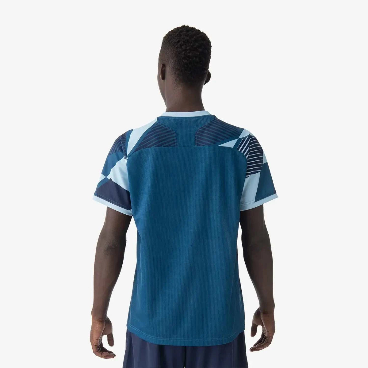 Yonex Men's Crew Neck Shirt in deep teal polyester, shown from the back with navy geometric shoulder and sleeve panels