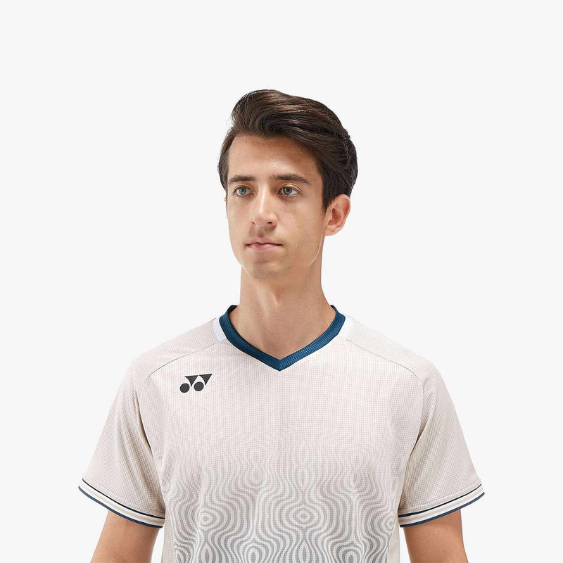 Yonex Men's Crew Neck Shirt in oatmeal-toned white polyester, with a blue-trimmed V-neck and subtle wave pattern.