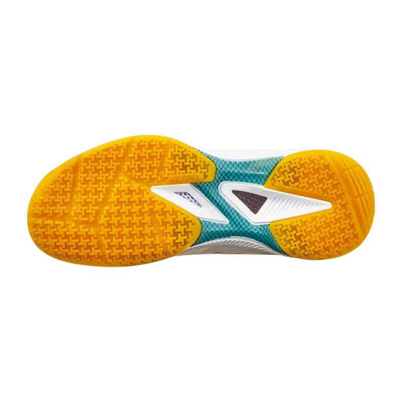 Yonex Power Cushion 65 Z4 LX badminton shoe outsole with bright yellow-orange grip pattern and teal, white, and gray midsole details