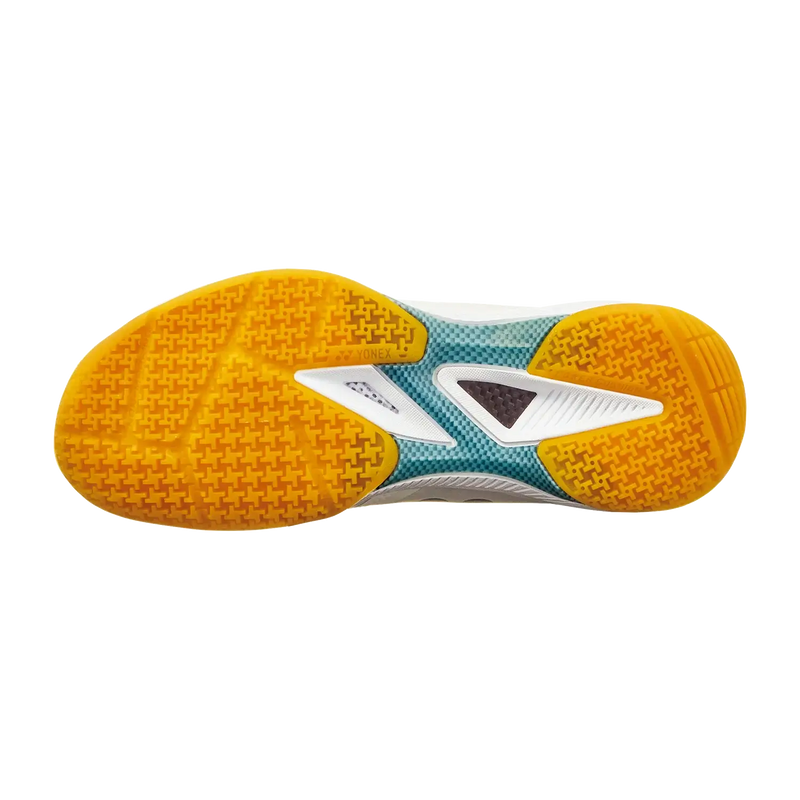 Yonex Power Cushion 65 Z4 badminton shoe outsole with bright orange textured rubber grip, teal and white midsole accents