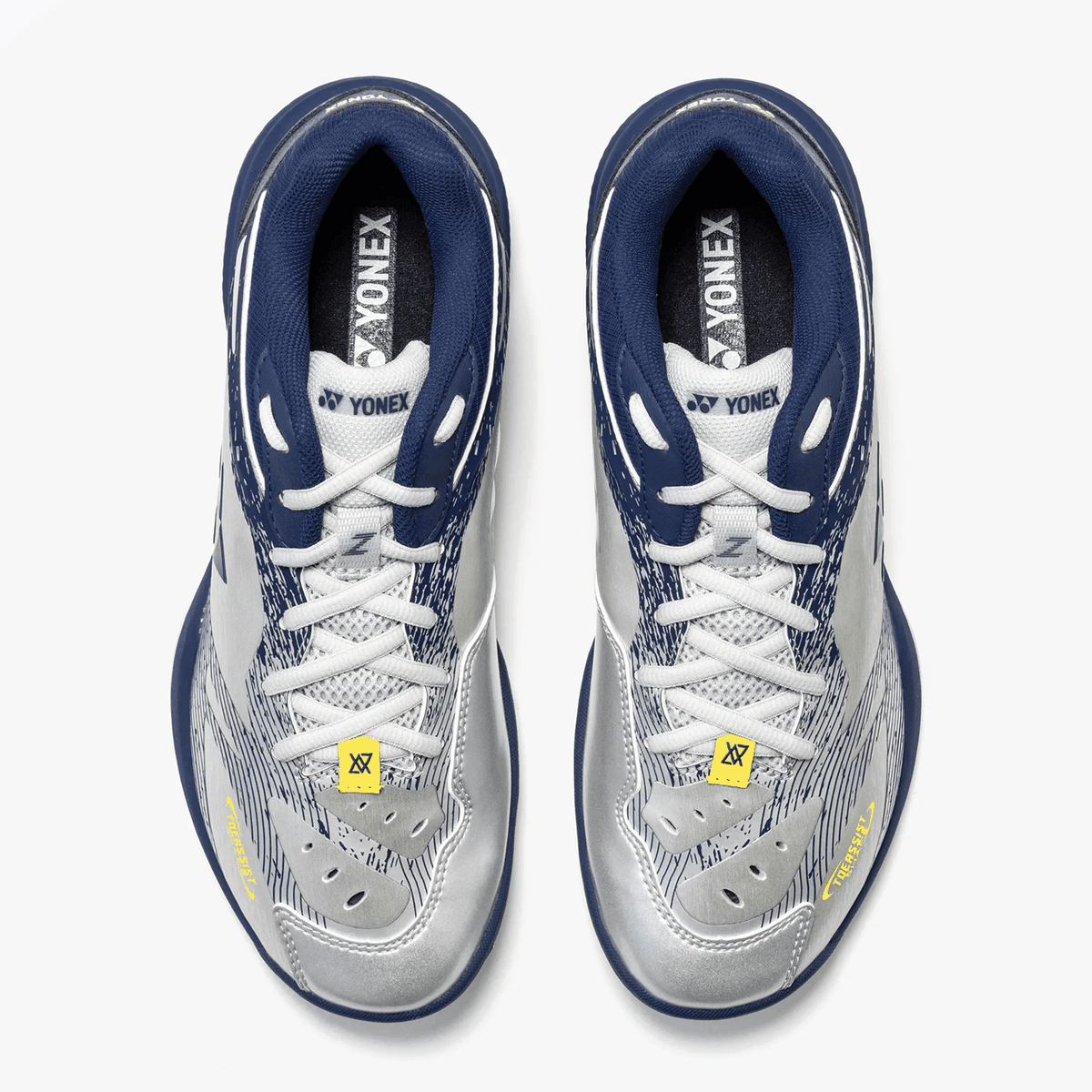 Yonex Power Cushion 65 Z4 badminton shoes in silver and navy with breathable patterned uppers, white laces and yellow accents