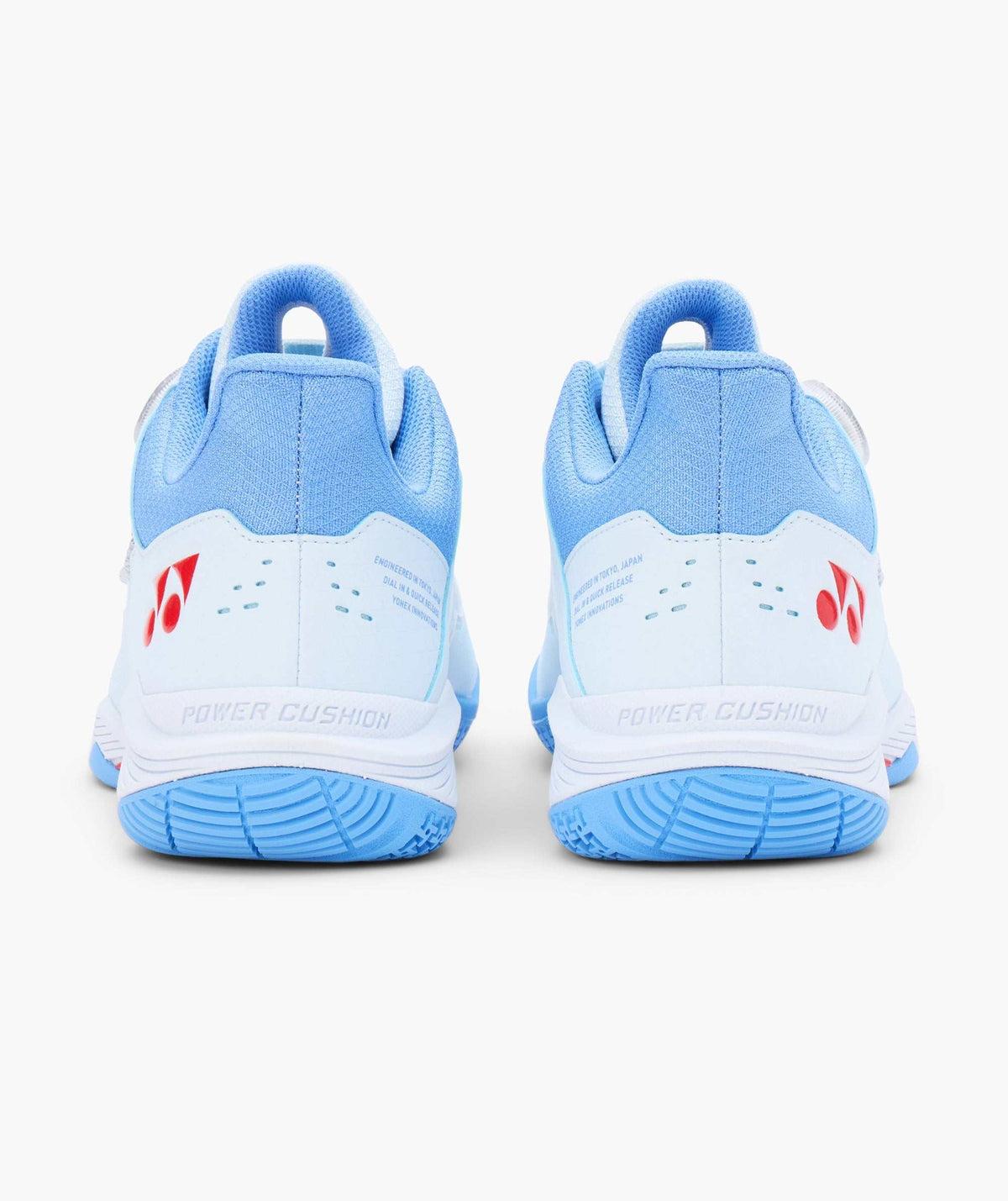 Yonex Power Cushion 88 Dial 3 badminton shoes in pale blue and white, viewed from the rear with red logos and textured soles
