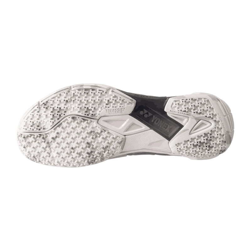 Yonex Power Cushion Cascade Drive 2 badminton shoe with a matte white patterned rubber sole and black midfoot panel
