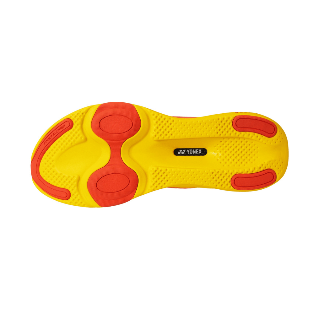 Yonex Prime Trainer Men badminton shoe outsole in bright yellow rubber with red grip pads and textured tread