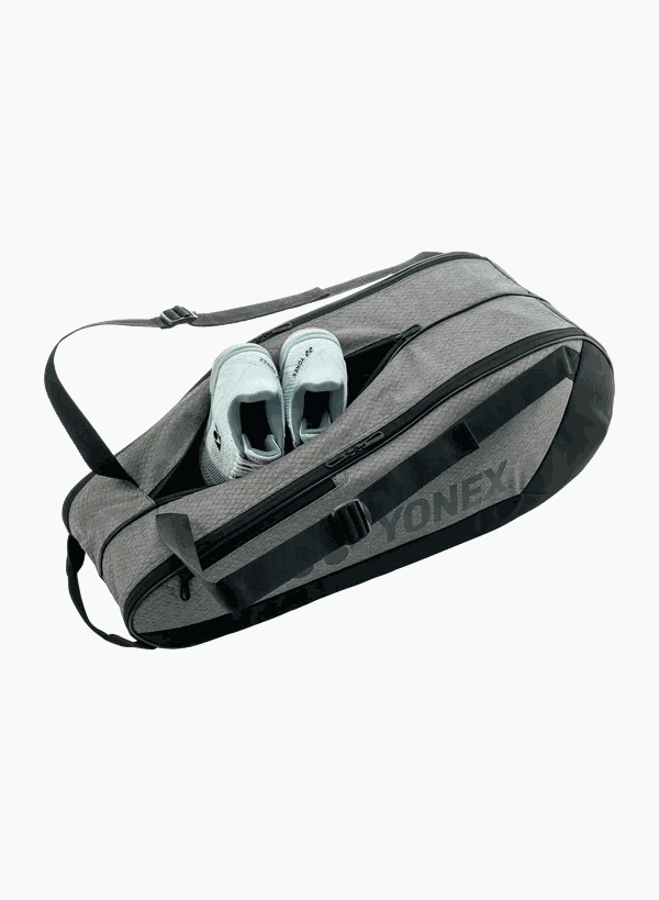 Yonex Team Series badminton bag in charcoal grey textured fabric with black trim, zip pockets and shoes visible inside