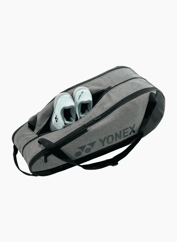 Yonex Team Series badminton bag in gray textured fabric with black zippers, shoulder straps and teal shoes visible inside