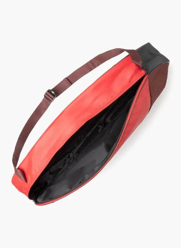Yonex Team Series badminton bag in red and black fabric, with an open main compartment and adjustable shoulder strap