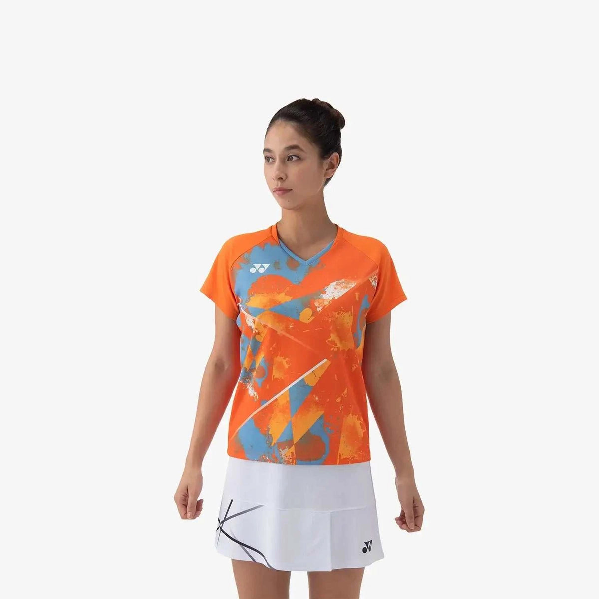 Yonex Women's Crew Neck Shirt in bright orange polyester with a blue and white abstract print and short sleeves