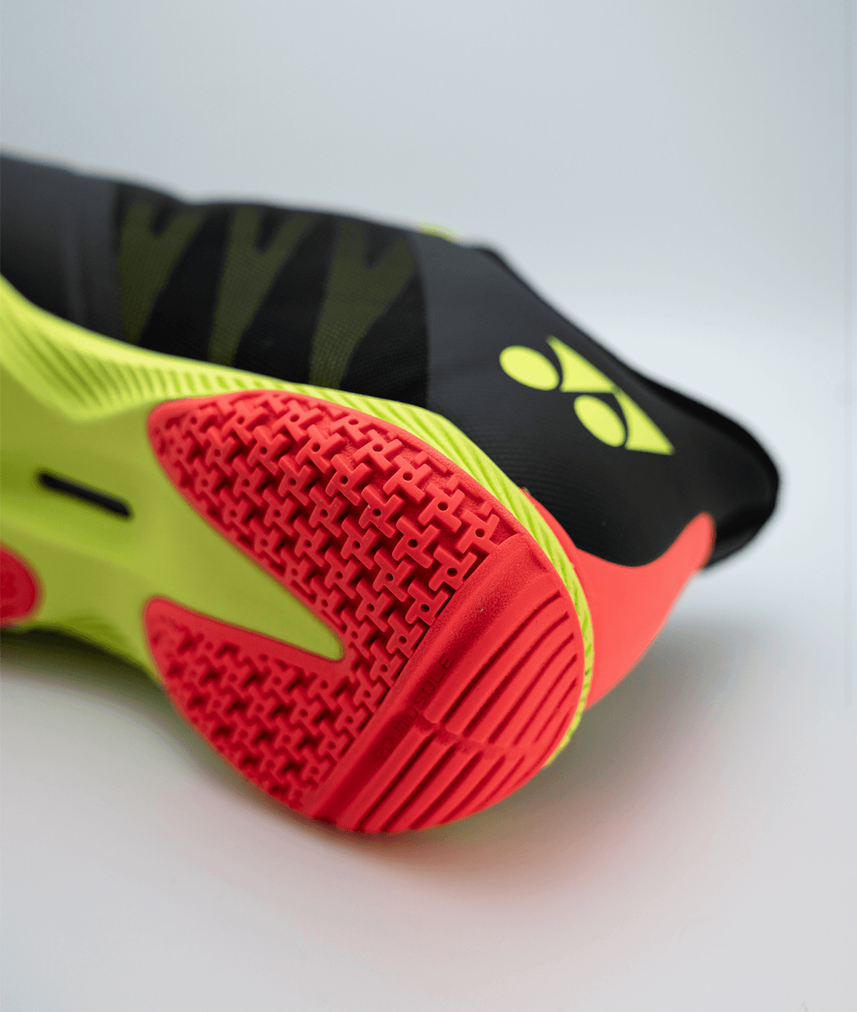 Yonex Power Cushion Comfort Z3 badminton shoe with a bright red patterned rubber sole and neon yellow, black upper